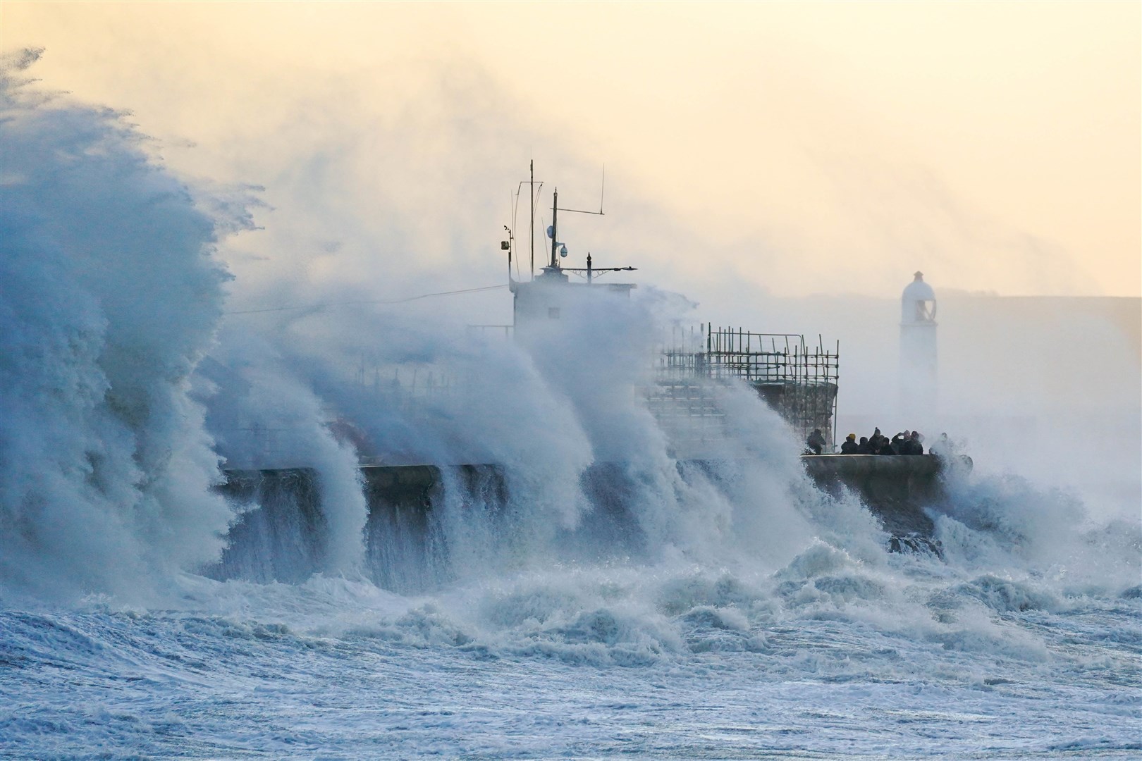 The immense power of the sea was clear to all as huge waves hit the sea wall at Porthcawl, south Wales, during a storm (Jacob King/PA)