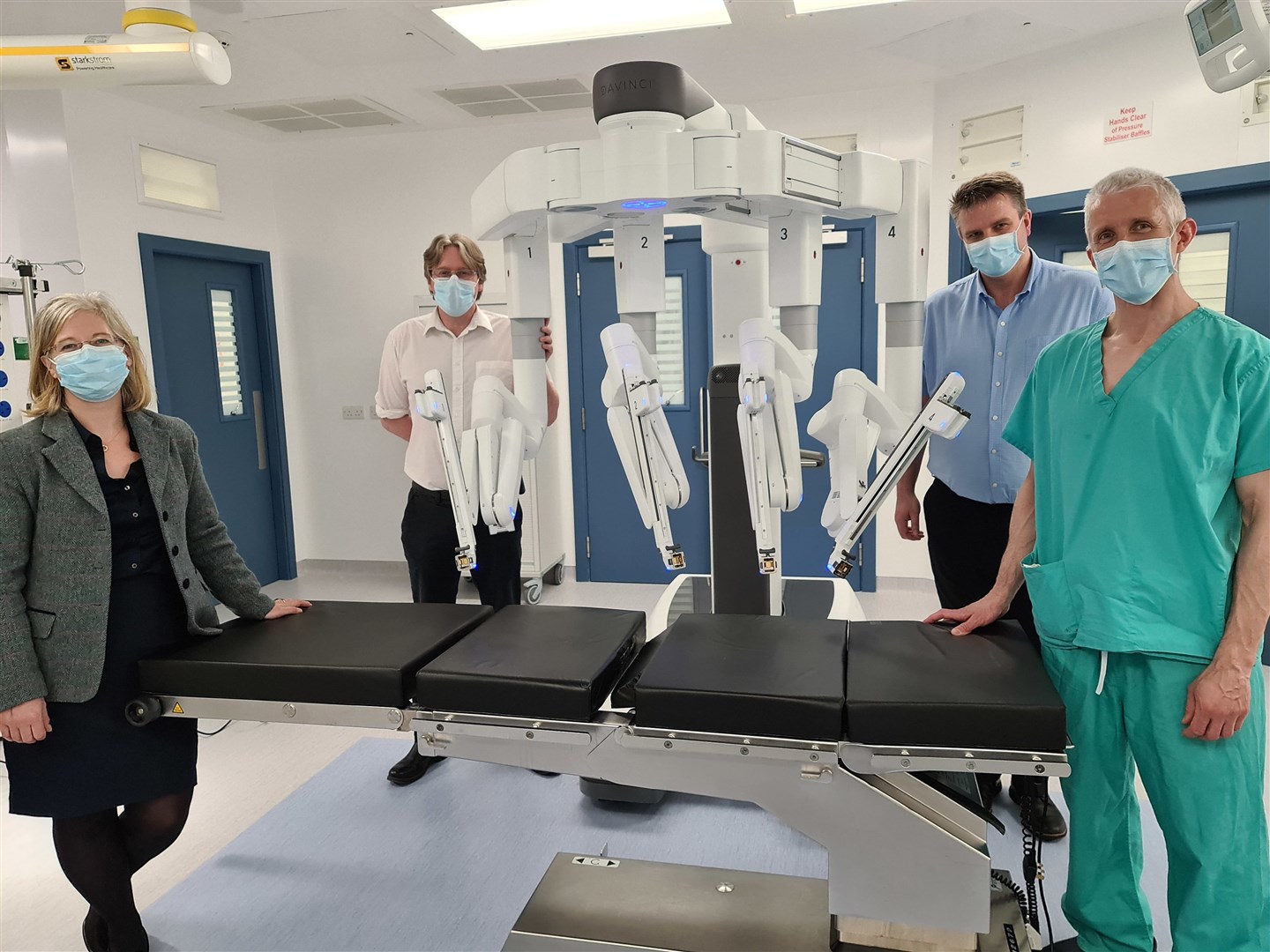 Deputy medical director (acute) Emma Watson with clinical director for surgery Alan Grant, service manager for theatres Kenny Oliver and consultant colorectal surgeon Colin Richards with the DaVinci Xi robot.