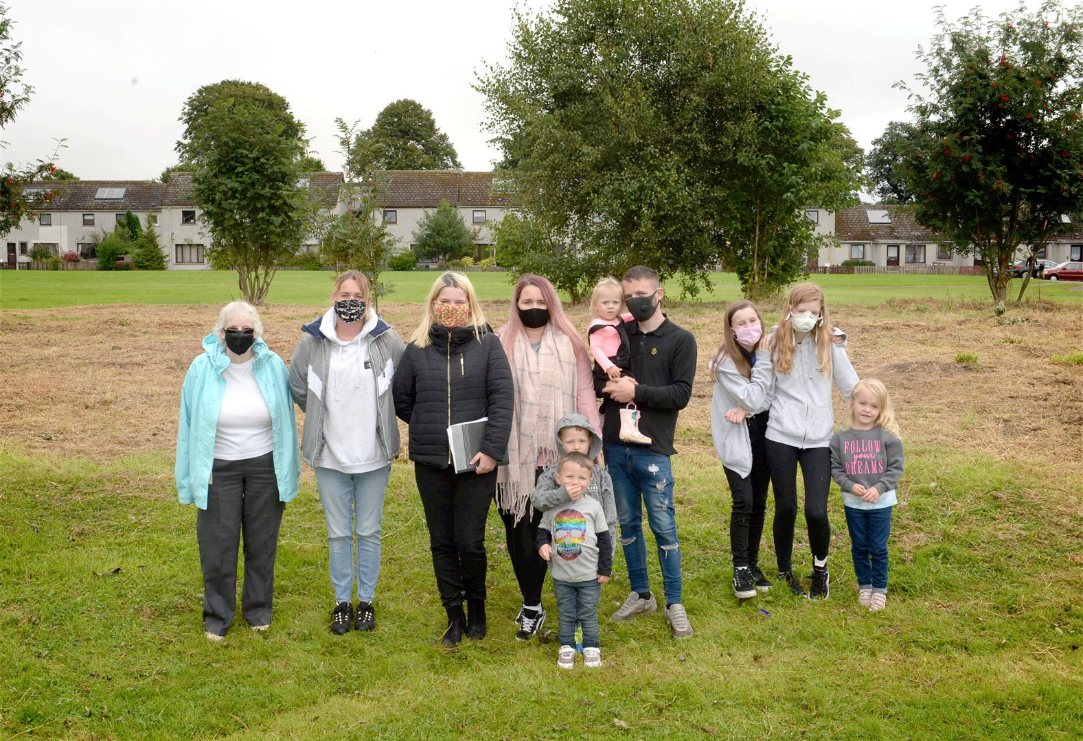 Communal area in Albyn scheme in Invergordon..Catherine Sutherland, Dana and Amy Sutherland, Shannen Murdoch, Stuart, Kaiden, Stuart and Aubrey Swanson, Emma Sutherland, Mollie Russell and Maisie Currie stood in front of the land that is being developed..Picture: James Mackenzie..