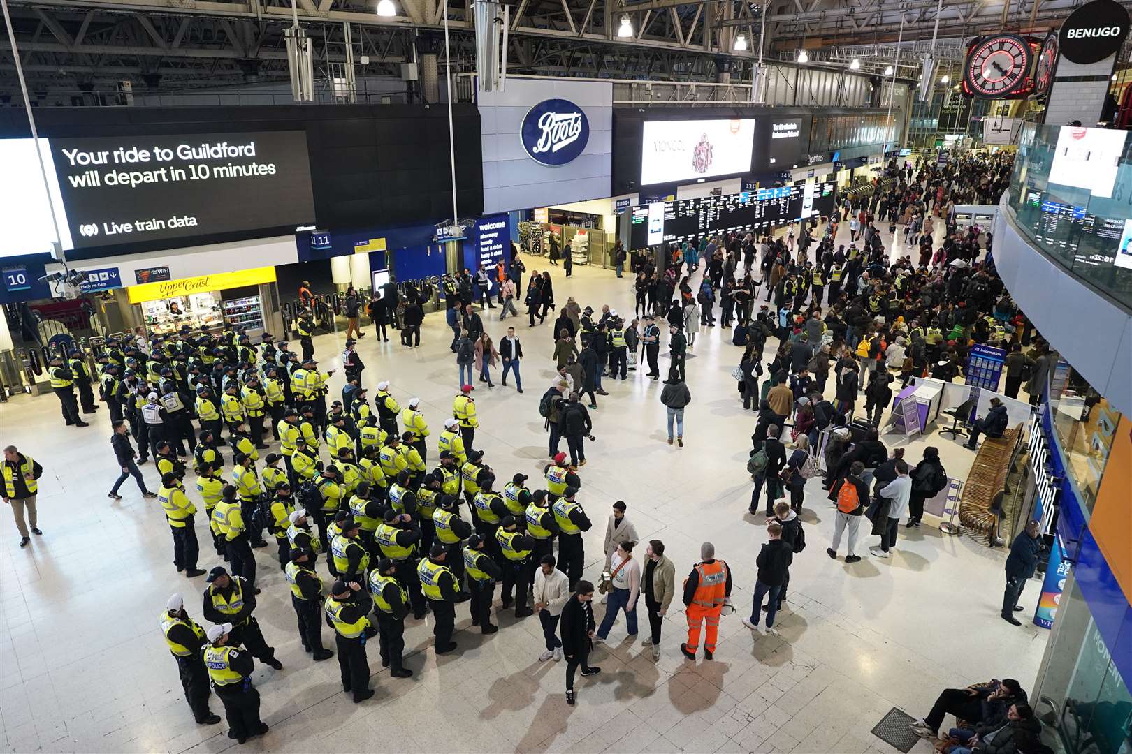 Police officers line up on the concourse after pro-Palestinian protesters took part in a sit-in demonstration at London’s Waterloo Station calling for a ceasefire in Gaza in November (PA)