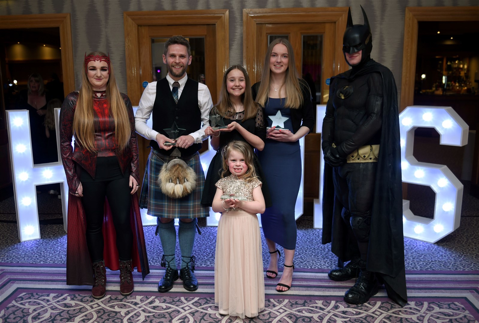 Some of this year's winners with superhero guests. Picture: James Mackenzie