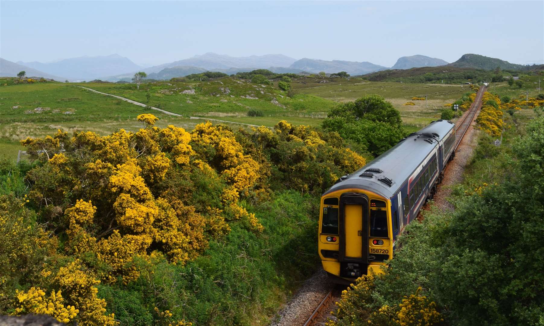 A ScotRail train approaches Duirinish station on the Kyle Line.