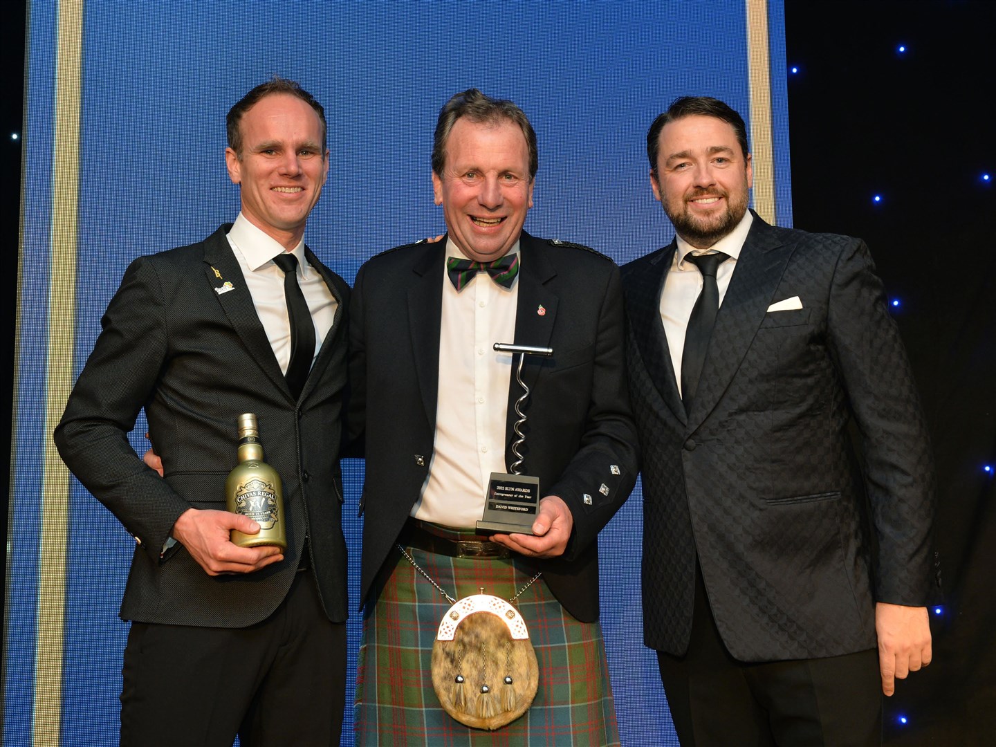 Award sponsior Mike Phillips, regional manager of Chivas Regal with SLTN entrepreneur of the year David Whiteford and awards host Jason Manford.