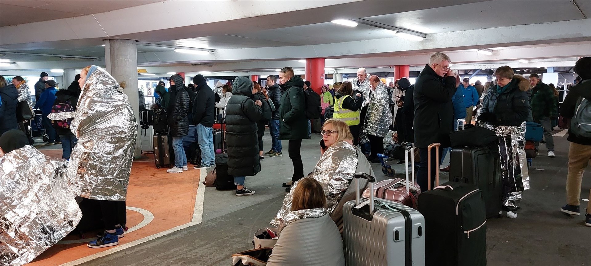 Passengers are waiting as some flights are being cancelled.