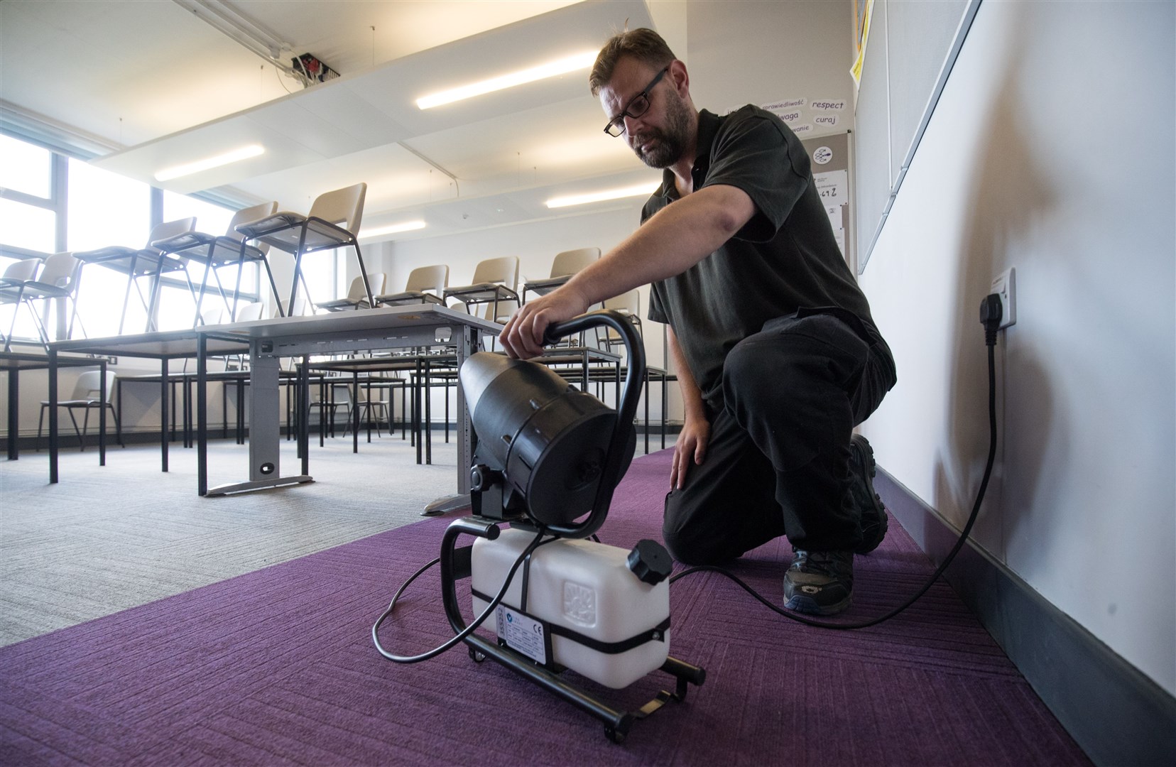 A fogging machine, which can disinfect a whole classroom, is set up in a classroom at Ark Charter Academy in Portsmouth (Andrew Matthews/PA)
