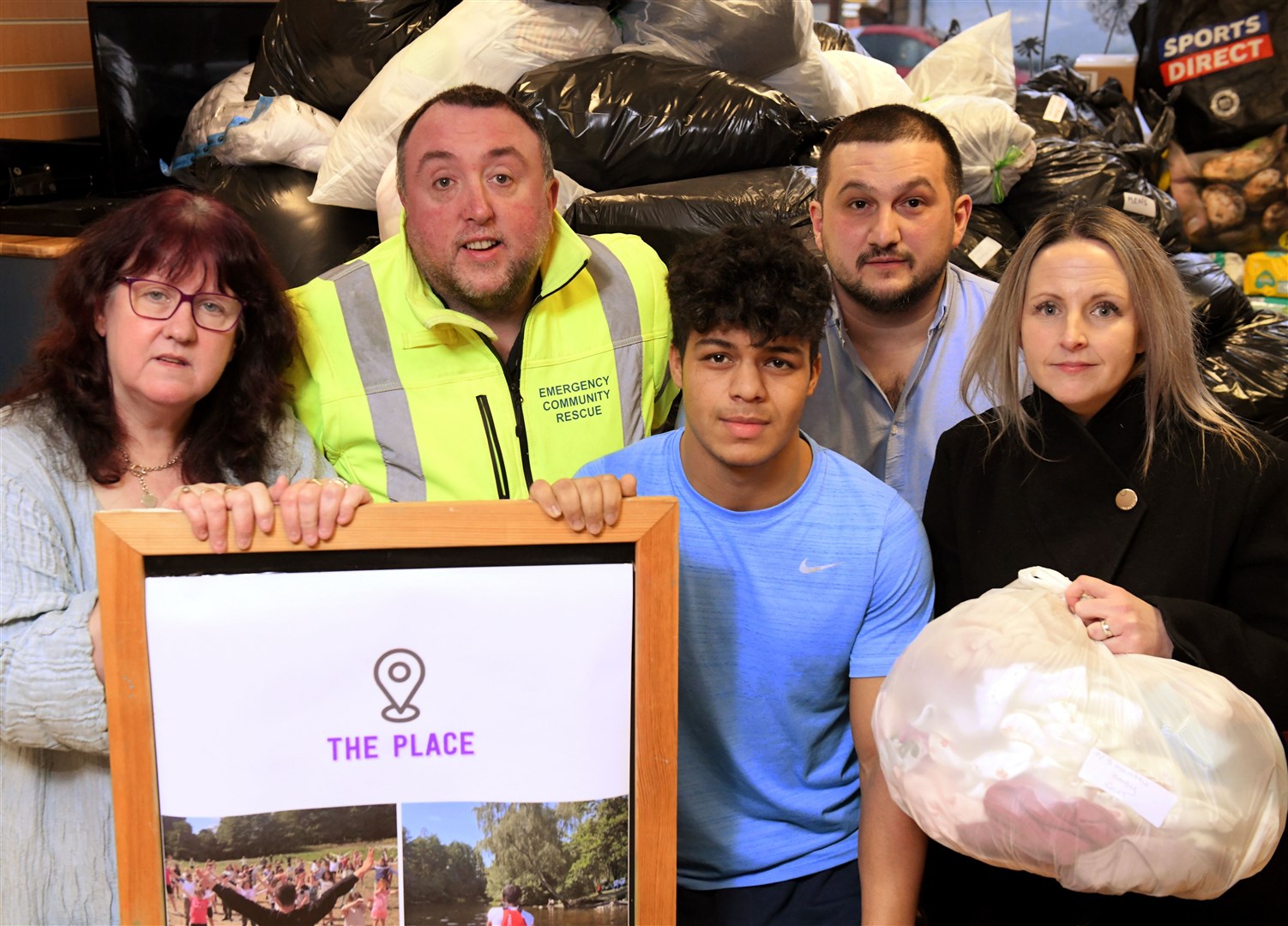 Janette Douglas of The Place, Michael O'Neill of Emergency Community Rescue, Shadi Ali, a Syrian living in Alness, Serhat Yavuz, a Turk living in Alness and his wife Carrie, a committee member at The Place with just some of the donations handed on. Picture: James Mackenzie.
