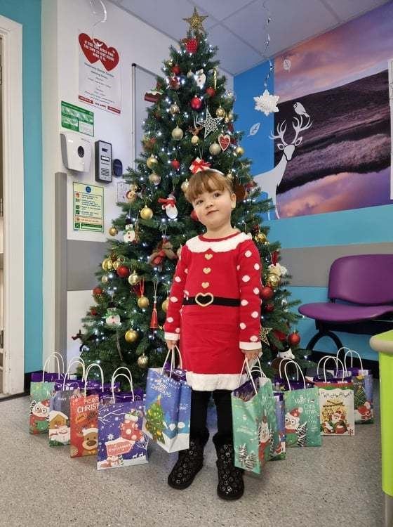 Maisie Star Torley hands over gifts at Highland Children's Unit at Raigmore Hospital.