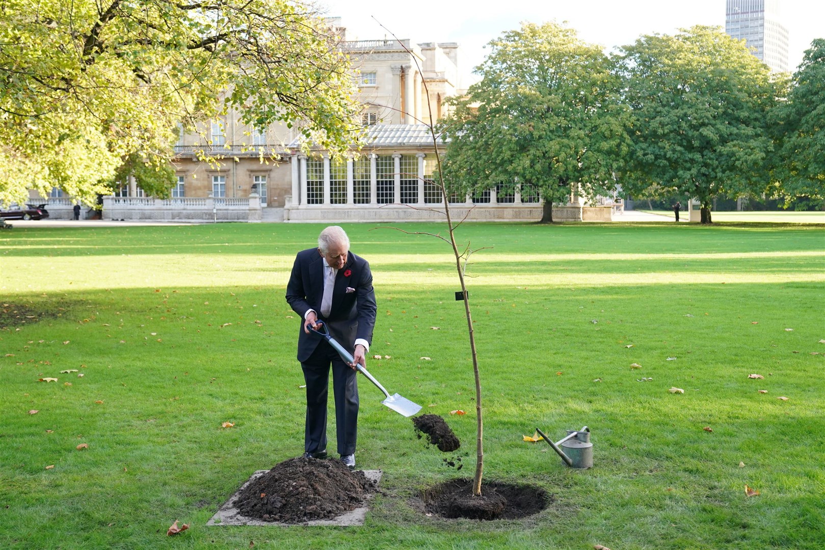 The King planting a lime tree near the Tea House in the Buckingham Palace garden (Jonathan Brady/PA)
