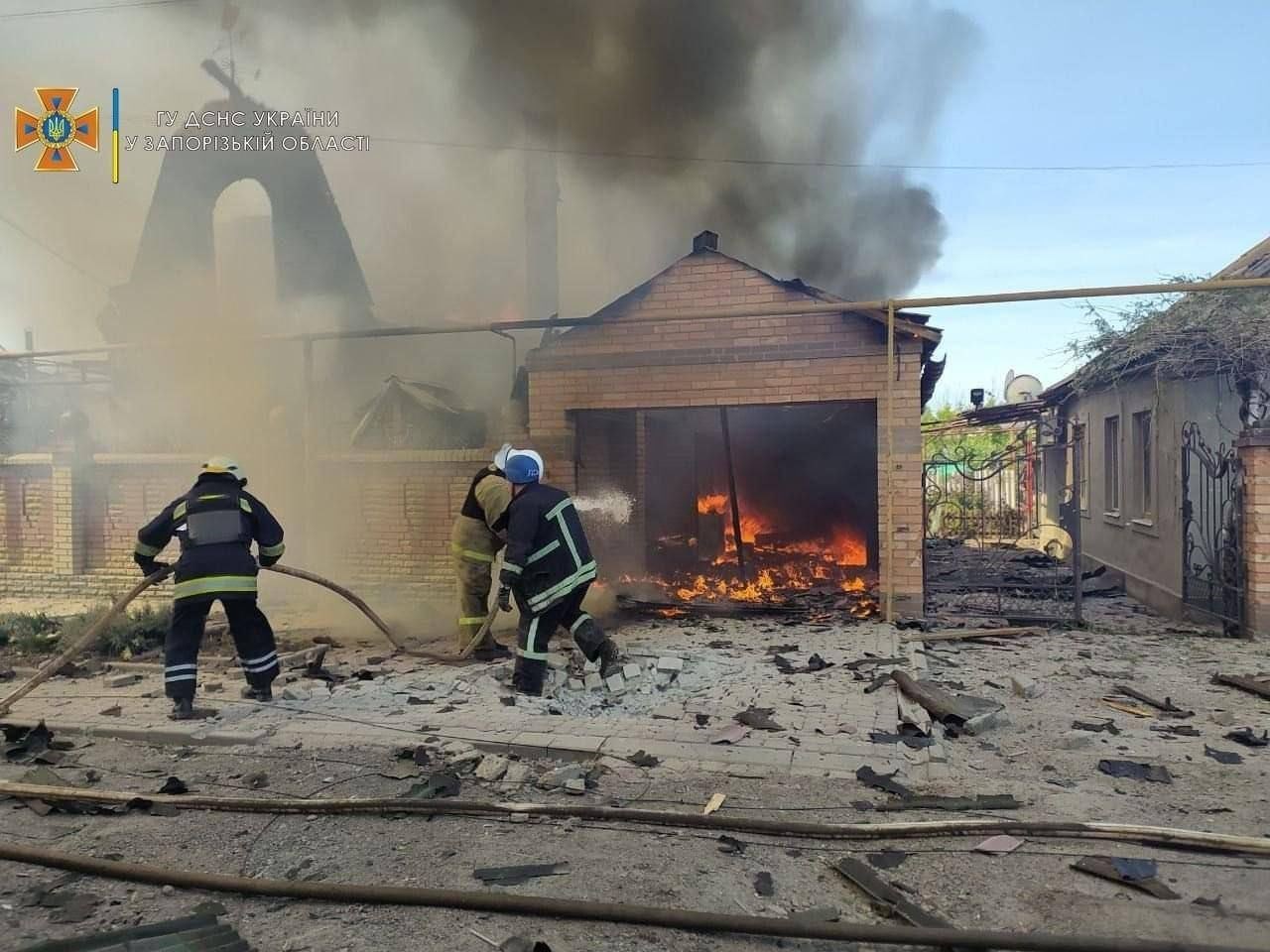 WAR ZONE: Julia and Stacy are from Zaporizhzhia which is currently under Russian occupation. Their street back home is pictured following a missile attack with Ukrainian firefighters putting out the fires.