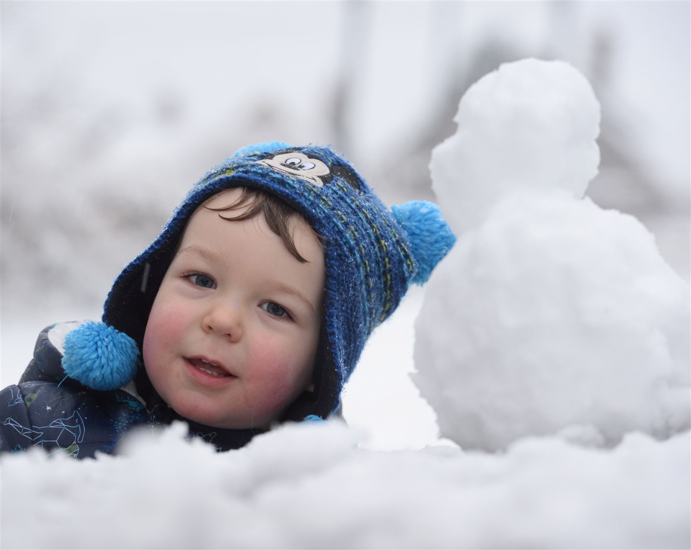 Snow on Black Isle.Rory Masson with his mini snowman...Picture: Gary Anthony..