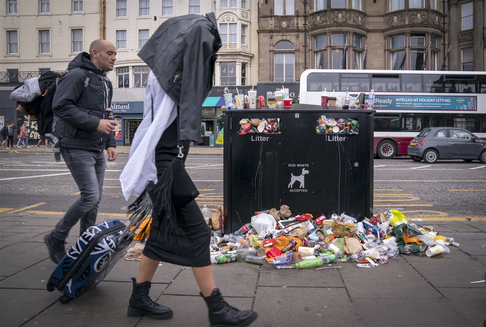 Bins overflowing in Edinburgh’s Princes Street as the mountains of waste in the city grow (Jane Barlow/PA)