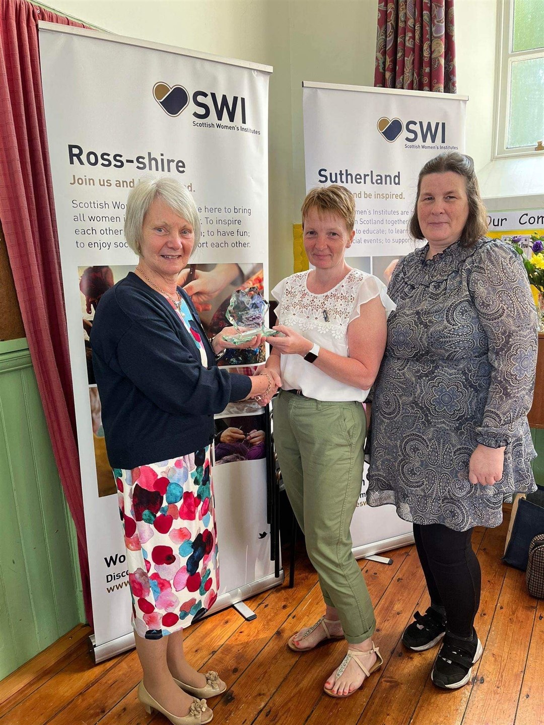 Pictured receiving the trophy from Ann McGhee is Linda Reid and Phyllis Hannah from Tarra Gals SWI.