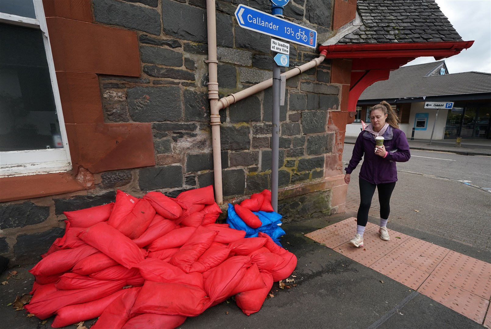 Sand bags sit piled against a wall in the main street in Aberfoyle, Perthshire (Andrew Milligan/PA)