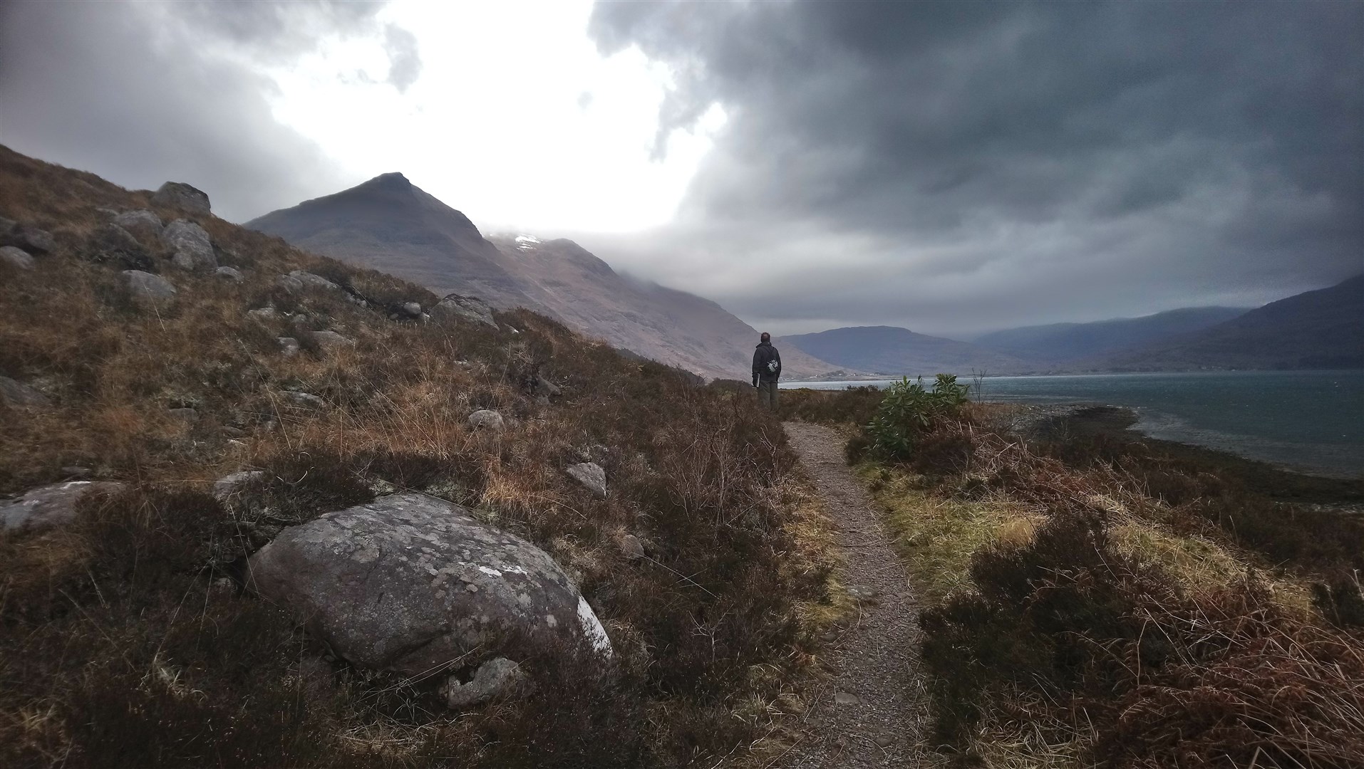 A walker gazes up at Liathach from above the shores of Upper Loch Torridon. Picture by Philip Murray.