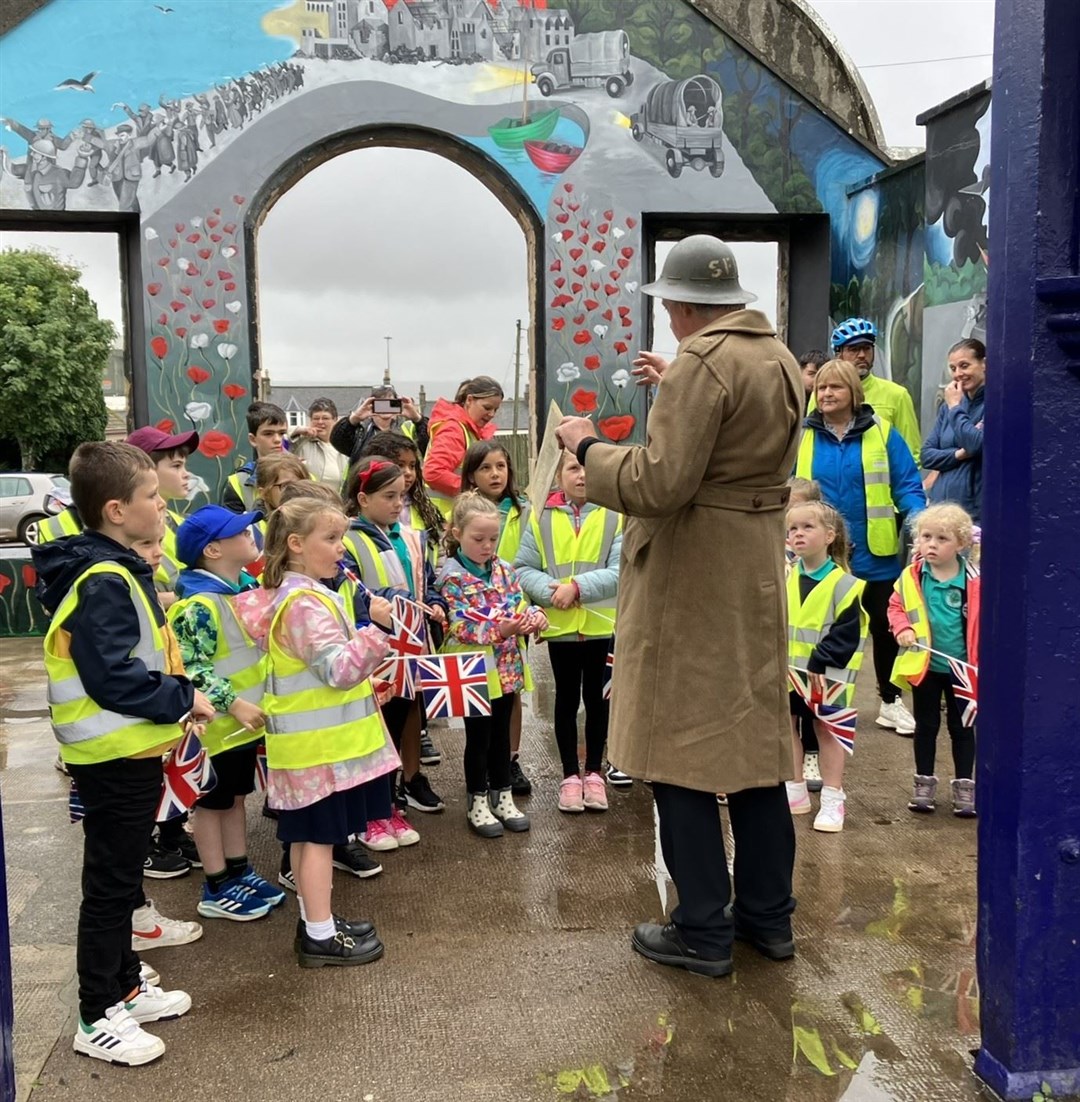 Pupils learning the history of the train station mural. Photo: Iona MacDonald.