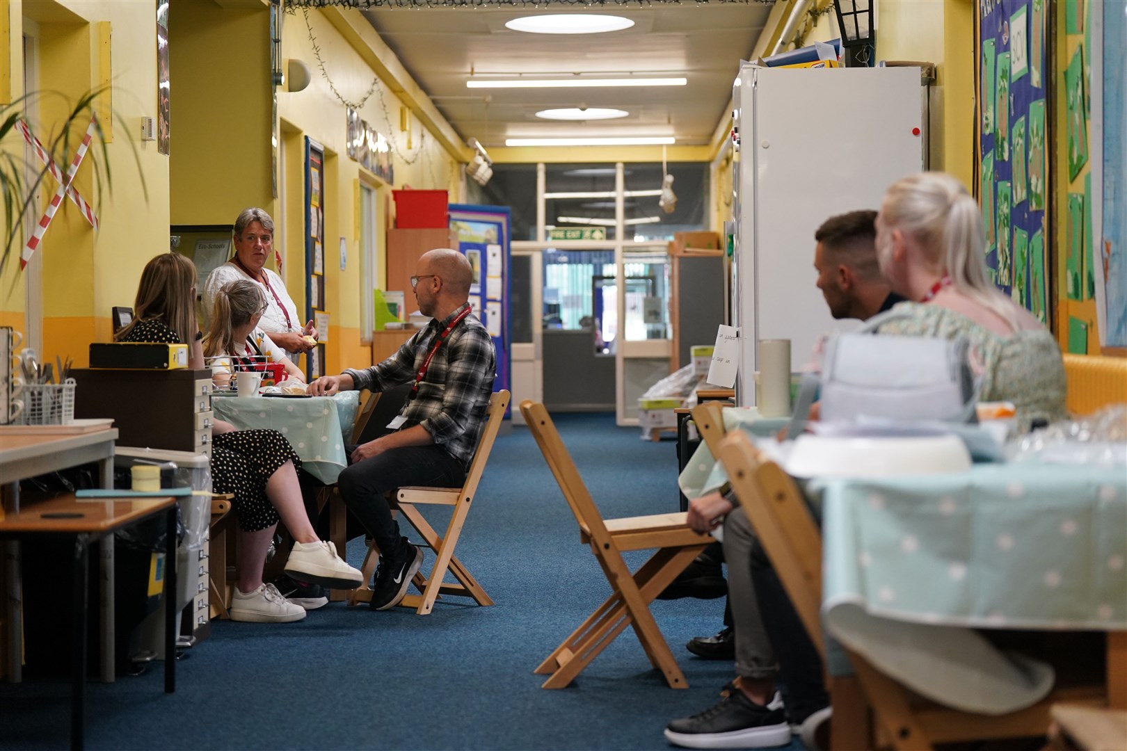 Head teacher Caroline Evans (top left) and staff members sit in a temporary staff room in the corridor of Parks Primary School in Leicester (Jacob King/PA)