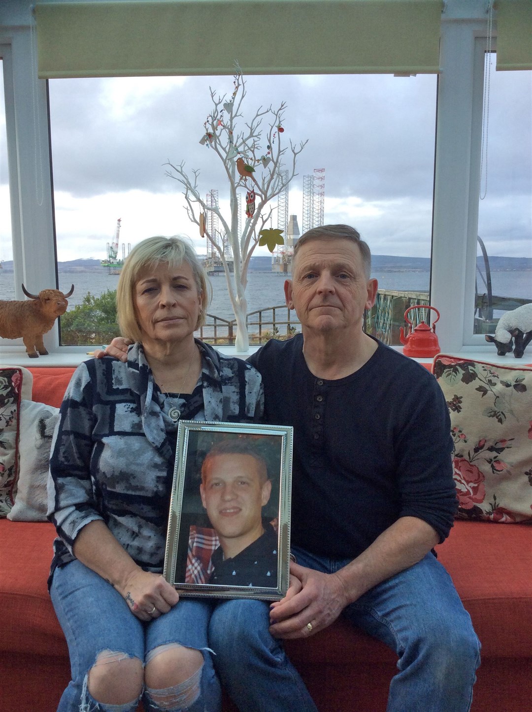 Wendy and Patrick Mullery with a picture of their son, James..
