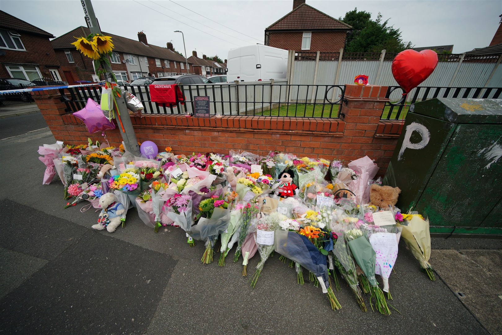 Flowers are left near to the scene of the shooting (Peter Byrne/PA)