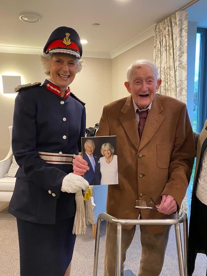 The Lord Lieutenant Mrs Joanie Whiteford and Lou McKenna with his birthday card from The King and Queen Consort.
