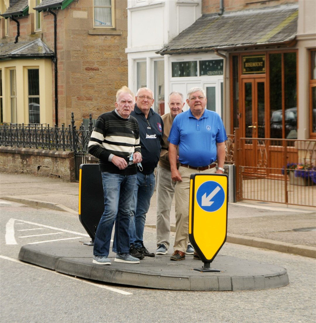 Allan Cameron, Charlie Thain and Gordon Seaton with councillor Graham Mackenzie at one of the traffic calming islands in the town. Picture: James Mackenzie