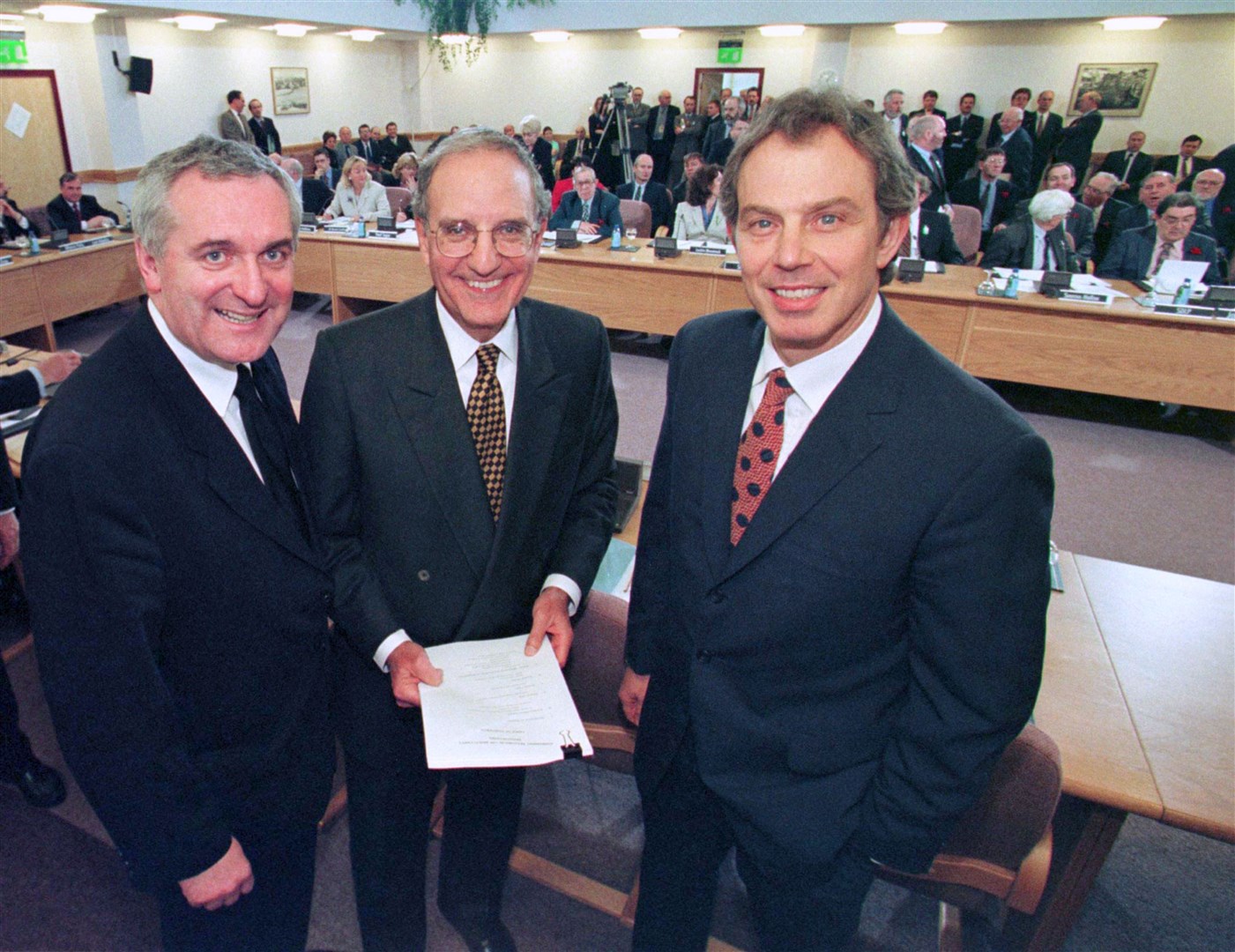 Irish premier Bertie Ahern, left, US senator George Mitchell, centre, and UK prime minister Tony Blair after they signed the Good Friday peace agreement (Dan Chung/PA)