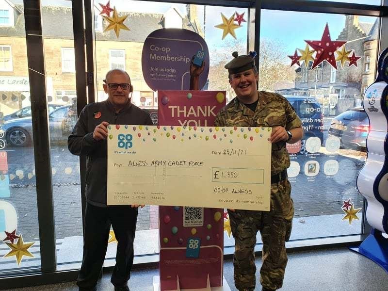 Lt Stuart Nicolson (right) accepting a cheque for £1350 from the Alness Co-op for the Alness detachment.