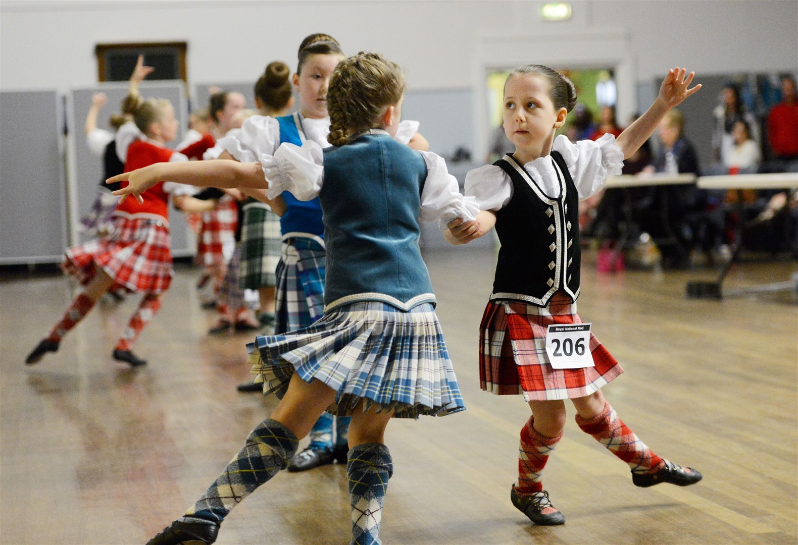 Rhianna Grant from Inverness (right) competes in the Beginners 7years and under category..Highland Dancing at the Mod 2014..Picture: Alison White. Image No.027144.