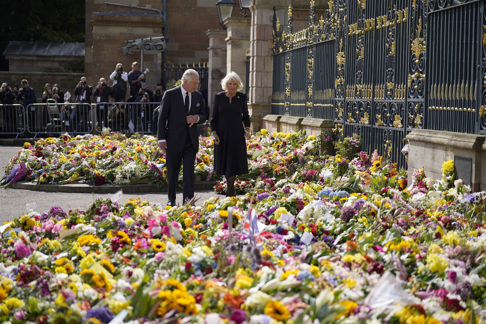 The King and Queen Consort look at floral tributes left at Hillsborough Castle (Niall Carson/PA)