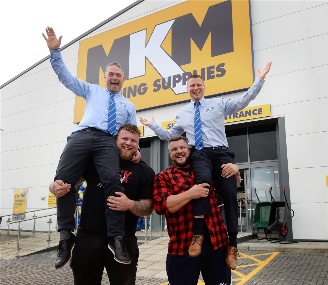 Branch directors of builder's merchant MKM Inverness, Mark MacDonald and Graeme MacLeod, get a lift from Ross-shire strongmen Tom and Luke Stoltman. Picture: Gary Anthony
