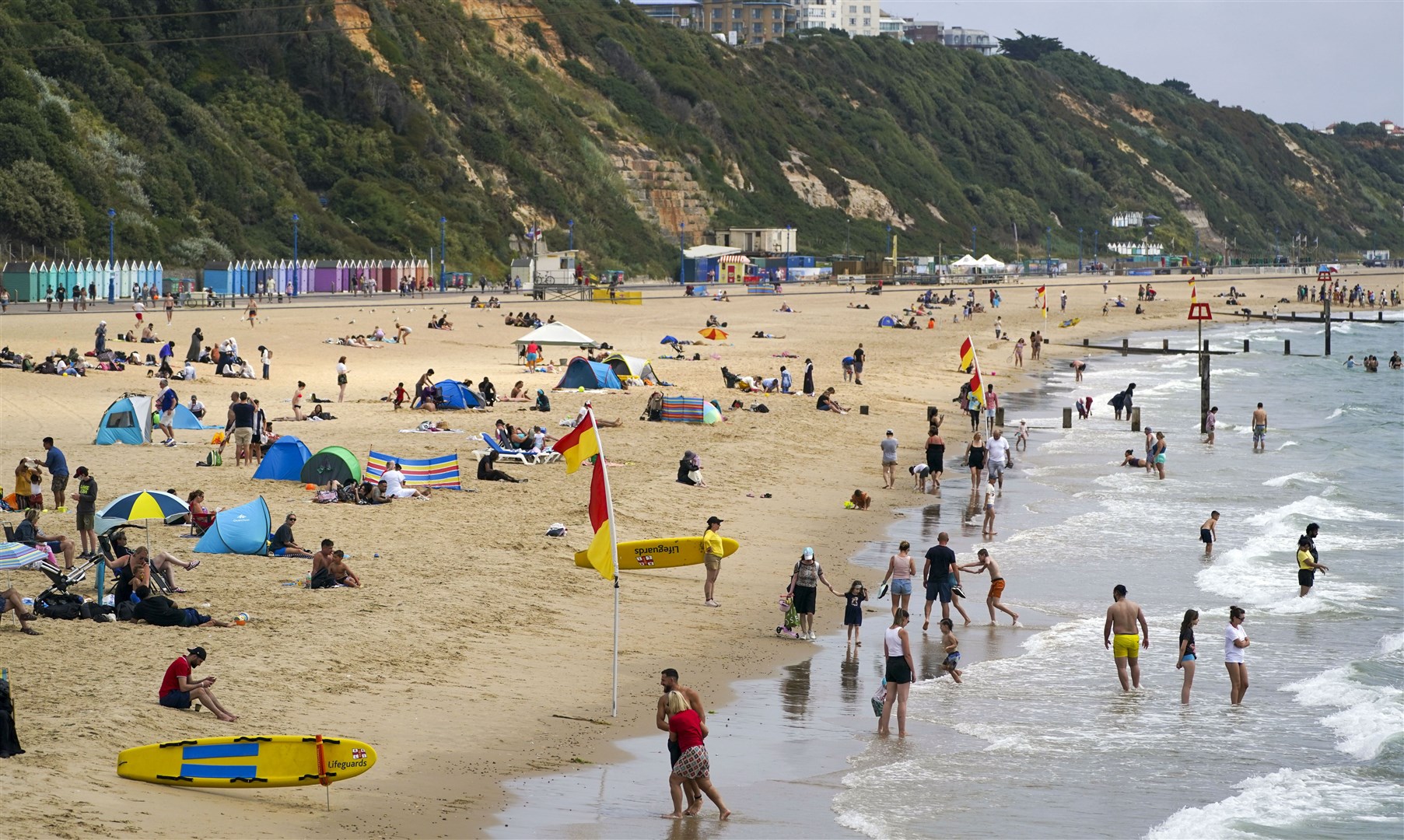 People enjoying the hot weather on Bournemouth beach after temperatures topped 40C in the UK for the first time ever (PA)