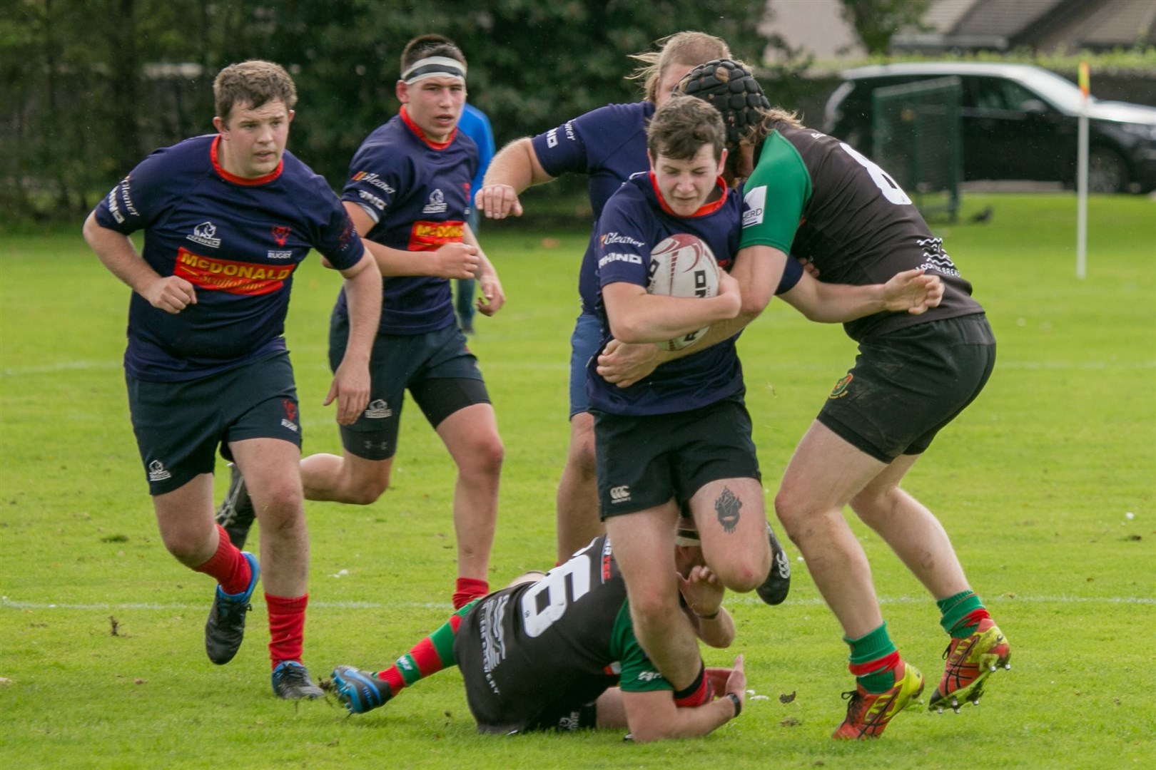 George Richardson attempts to break through a Highland 2nds tackle to keep Ross Sutherland movong up the pitch. Picture: Peter Carson