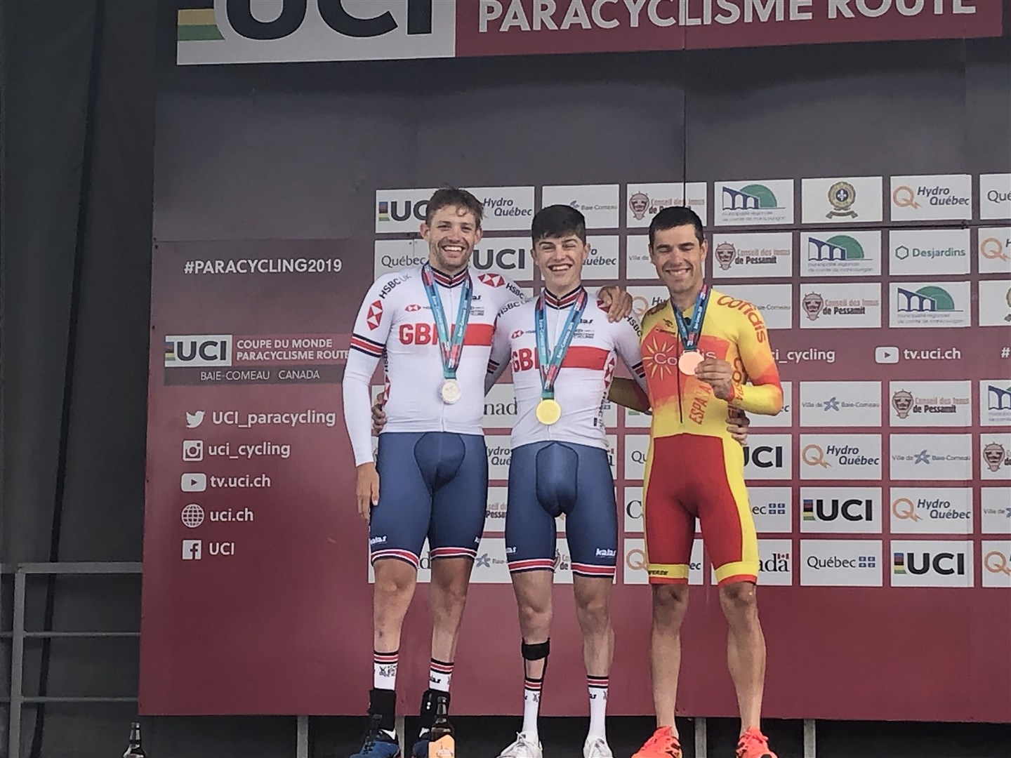 Fin Graham (centre) celebrates on the podium as he won two gold medals at the road world cup in Canada.