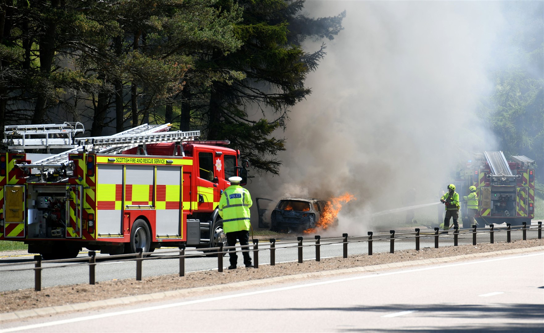 The car was engulfed in flames, according to a passing motorist.