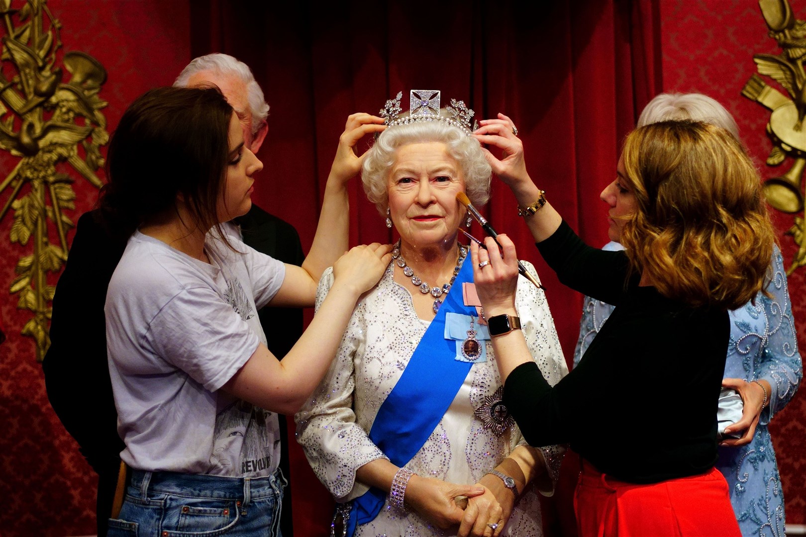 Studio artists Luisa Compobassi (left) and Jo Kinsey (right) make their final touches to the wax figure of Queen Elizabeth II at Madame Tussauds London ahead the Platinum Jubilee celebrations. (PA)