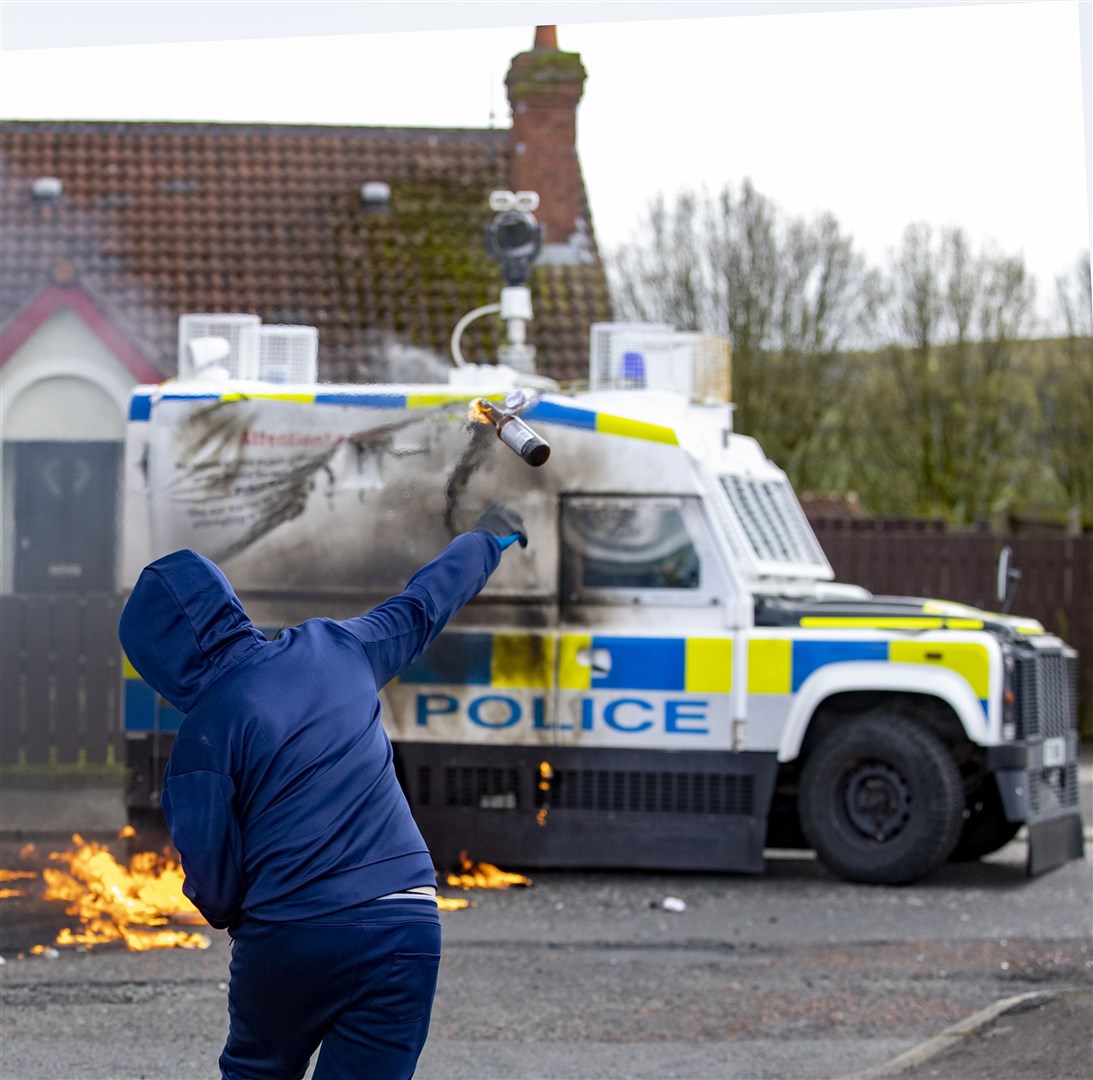Youths throw petrol bombs at a PSNI vehicle ahead of a dissident Republican parade in the Creggan area of Londonderry on Easter Monday (PA)