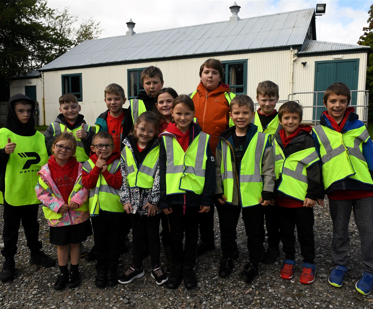Tore Primary School pupils in front of the highly prized village hall now in need of upgrade. Picture: James Mackenzie.