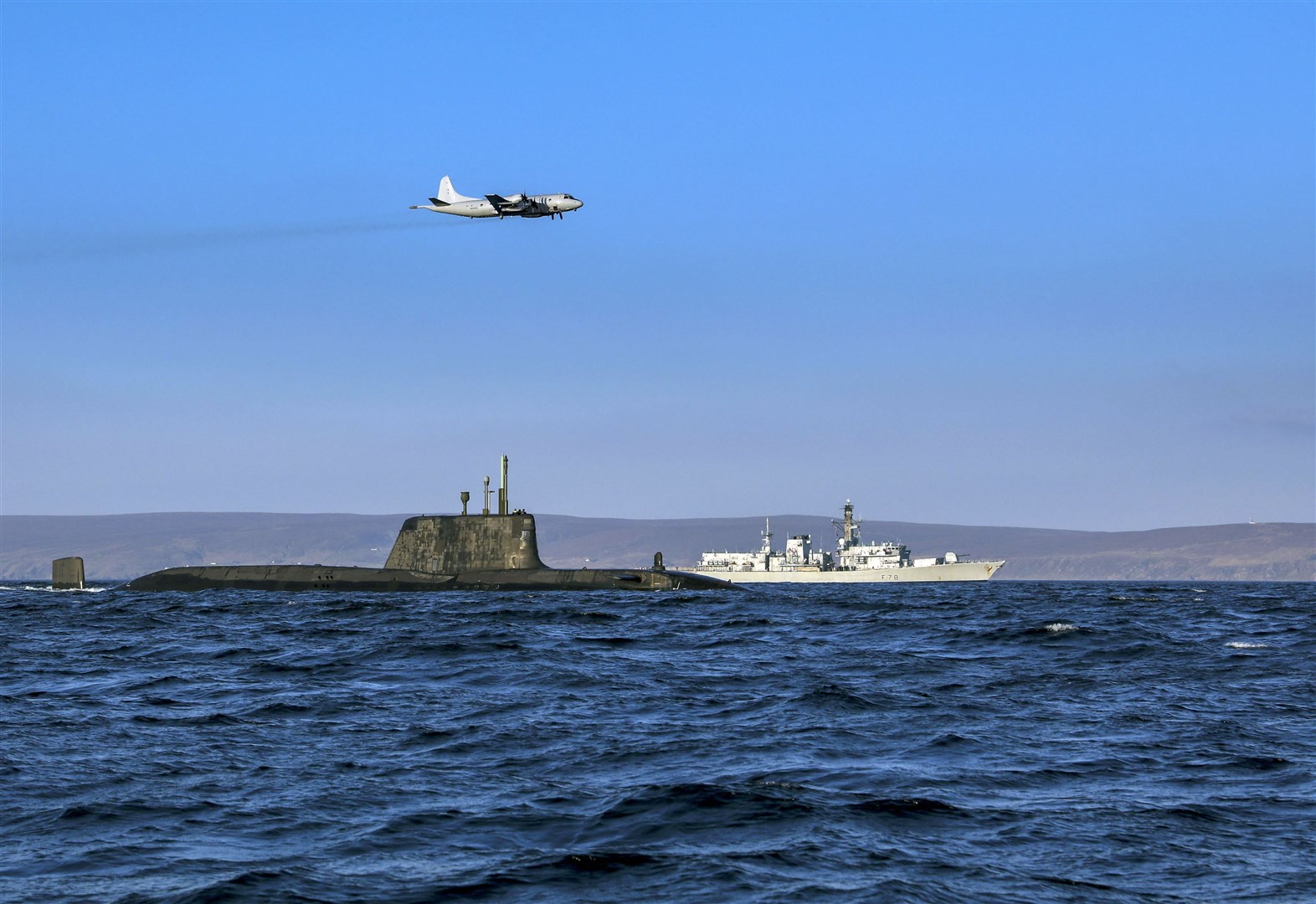An Astute class nuclear submarine in company with the Type 23 frigate HMS Kent being over flown by a German Navy P3 maritime patrol aircraft.
