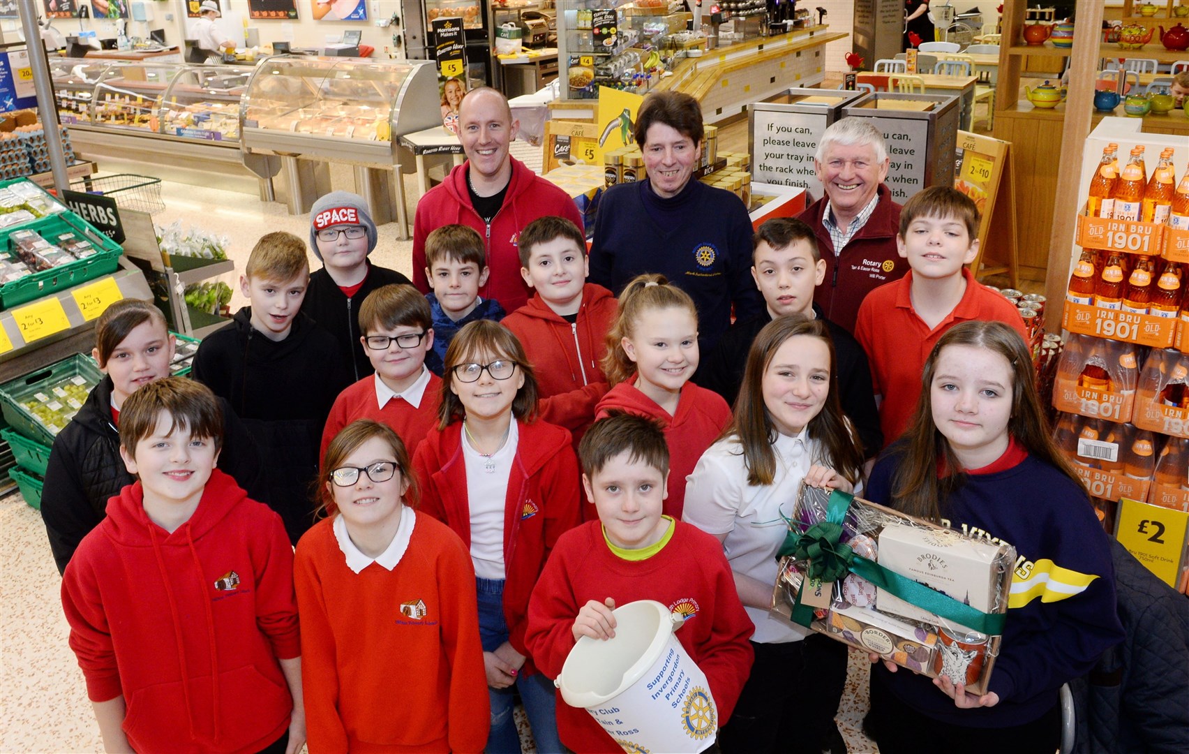 Pupils from Milton and South Lodge Primary on bag pack duty at Morrisons in Alness with South Lodge head teacher David Hayes (rear left),Tain and Easter Ross Rotary members Mark Sutherland-Fisher and Will Porter. Picture: Gary Anthony.