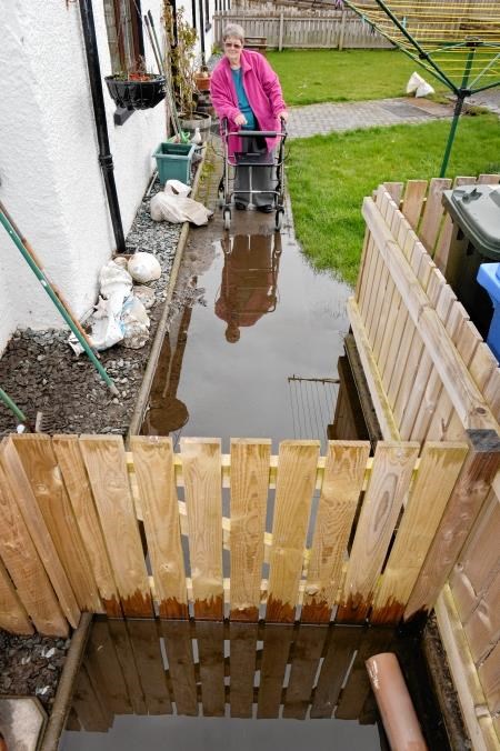 Judith White (70) has faced major problems getting around outside since flooding more than nine weeks ago. Picture: Gair Fraser