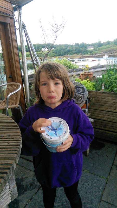 A glum Isla McWhinney with the plundered charity box