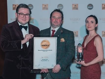 Gregg Glass (centre) receives his award from Christopher Coates (left) and Whisky Magazine editor Bethany Whymark (right). Picture: Oliver Riley-Smith