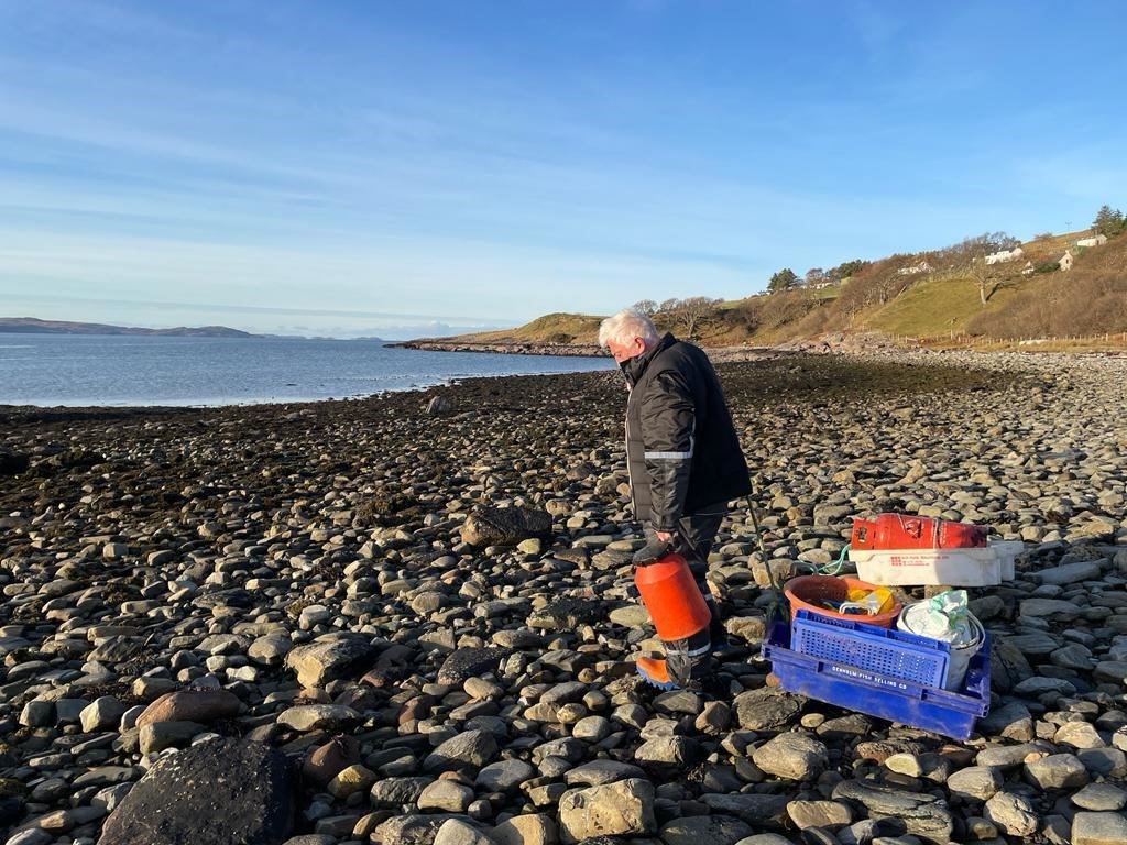 Environmental consultant for the Ullapool Sea Savers, Noel Hawkins with the debris washed ashore.