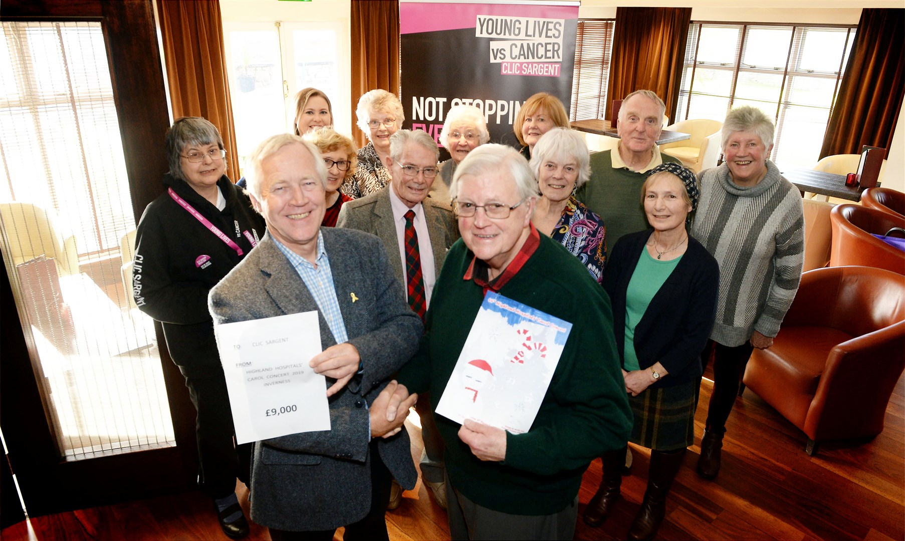 David Dean, (front right) gives the donation to Ian Gibson (front left) of Clic Sargent. Picture: James MacKenzie.