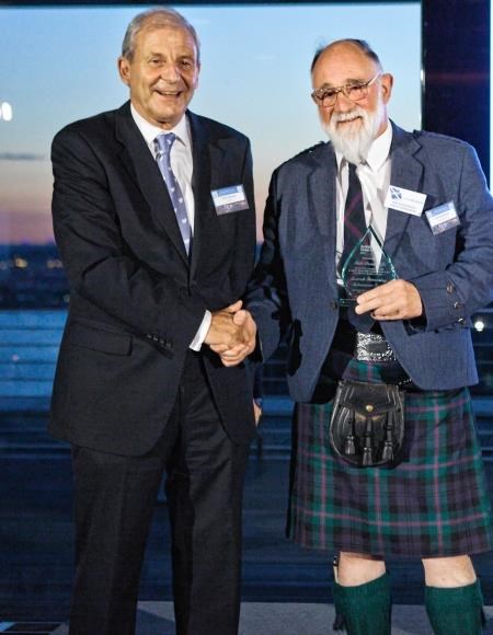 Cpt Iain Dunderdale (right) receives his award from Seatrade chairman Chris Hayman.