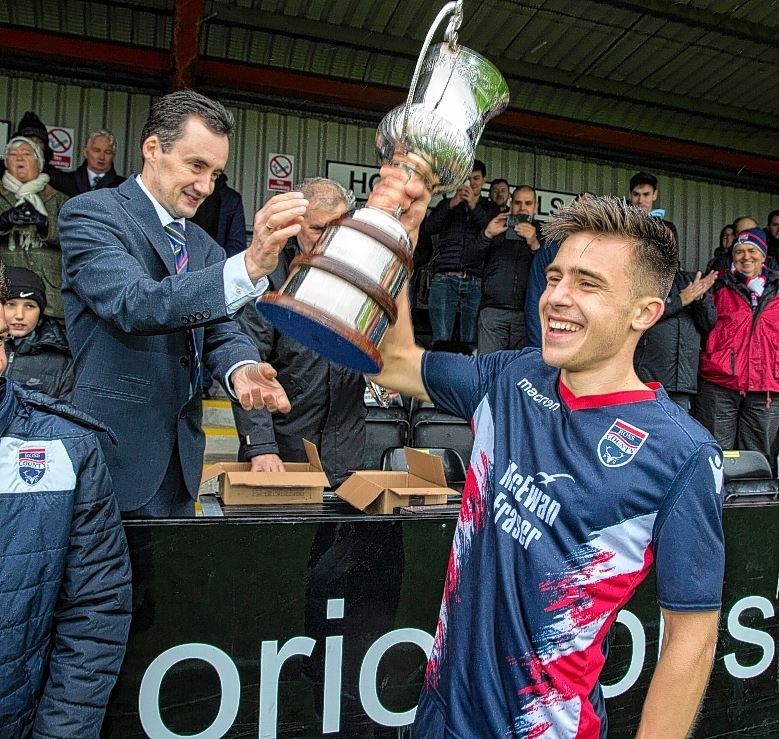 Ross County captain Ross MacIver with the Cup with the North of Scotland Cup. Picture: Ken Macpherson