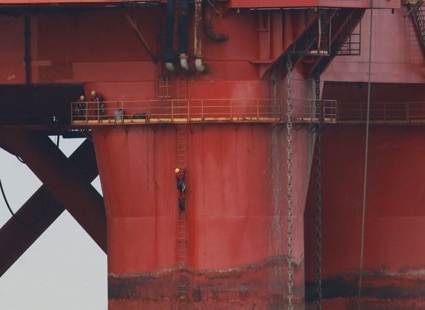 Protestors can be seen scaling the rig in the Cromarty Firth.