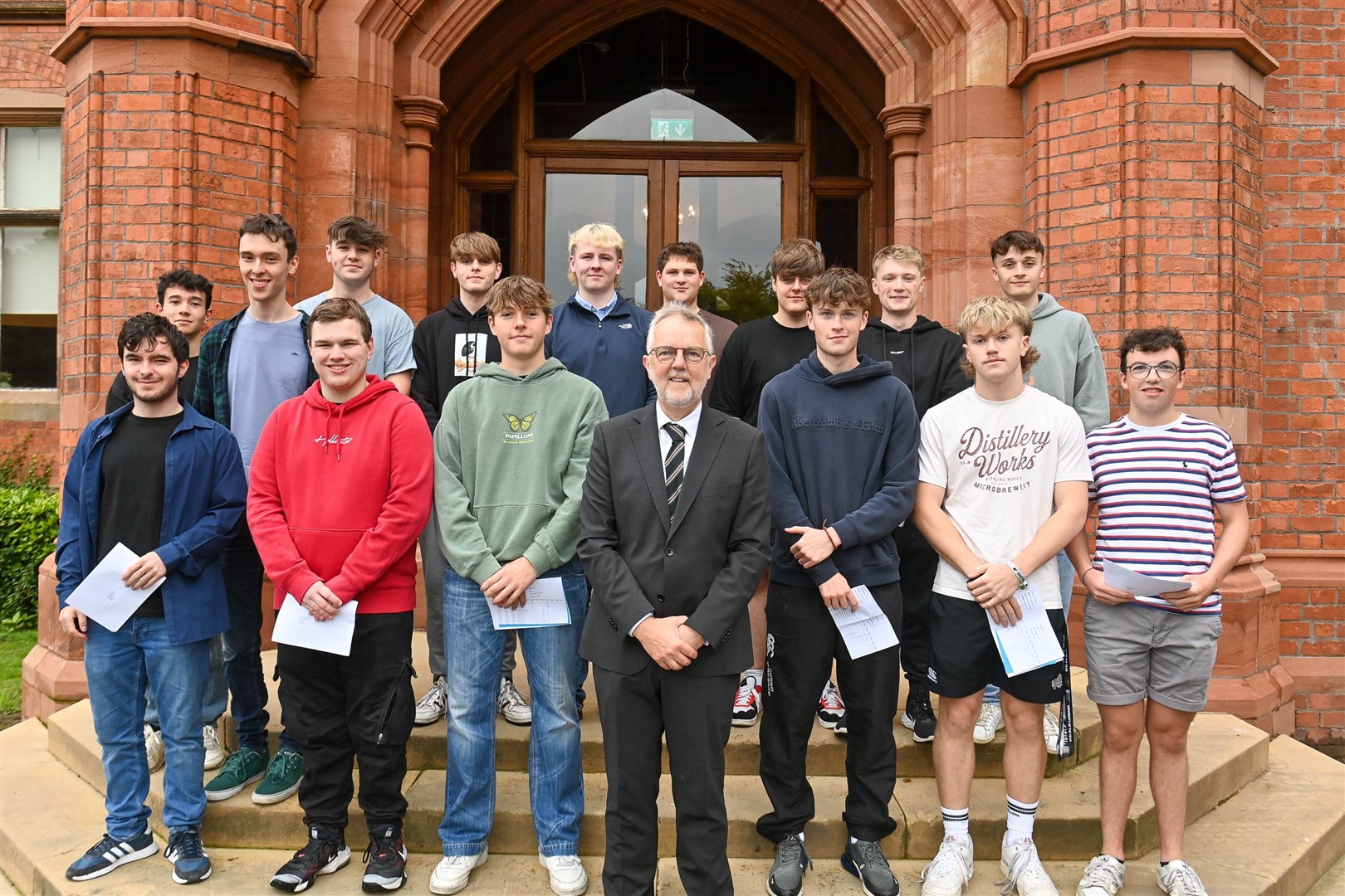 Headmaster of Campbell College Robert Robinson with students from the school on A-Level results day (PressEye/PA)