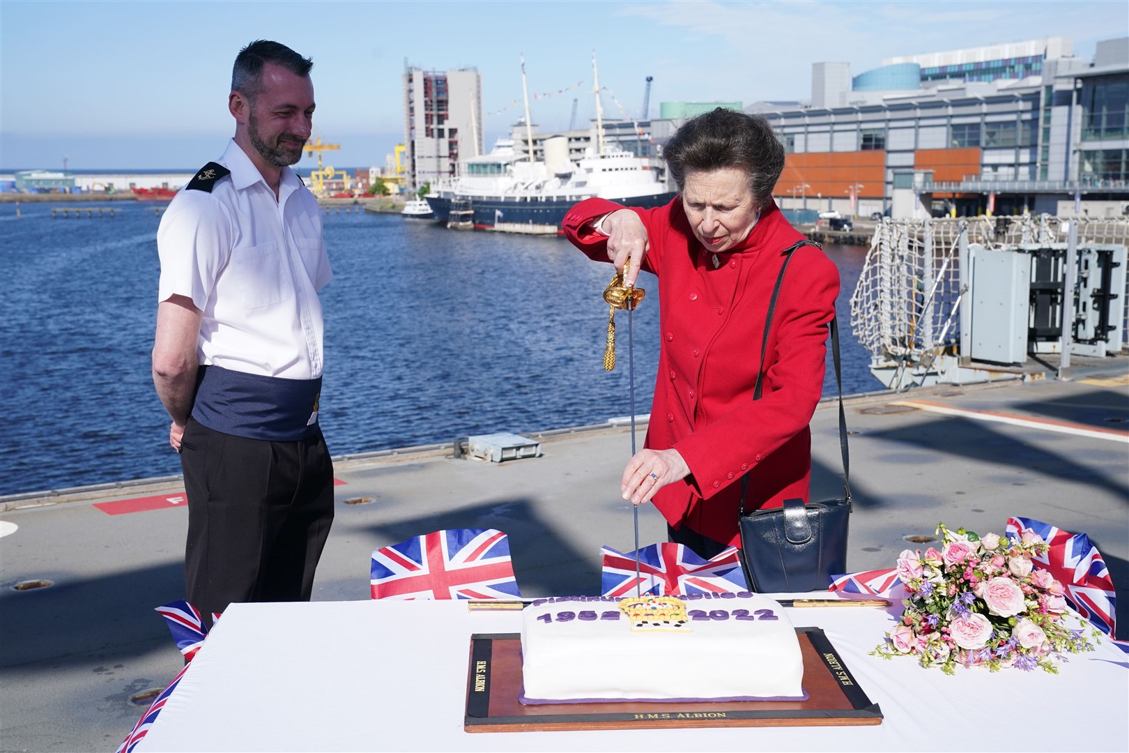 The Princess Royal cut a commemorative cake (Jane Barlow/PA)