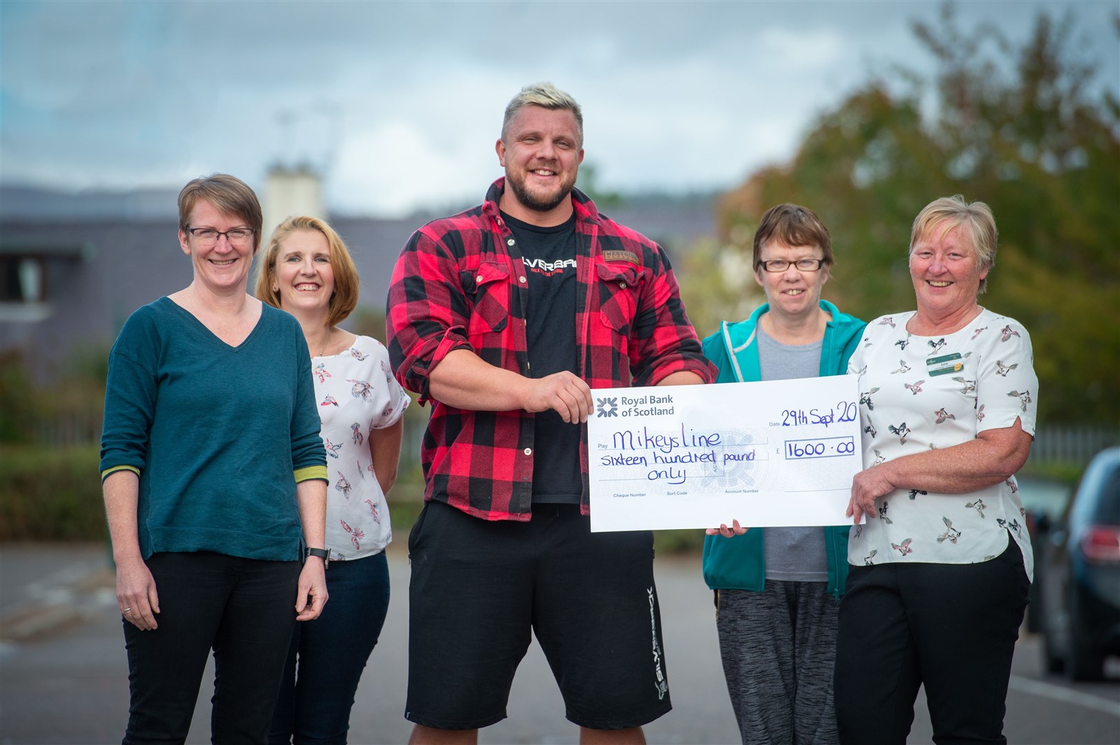 Flanking Luke Stoltman are (from left) Donna Smith of Mikeysline, Kirstine Morrison, Mandy Ross and June Ross, Morrisons' Alness community champion. Picture: Callum Mackay