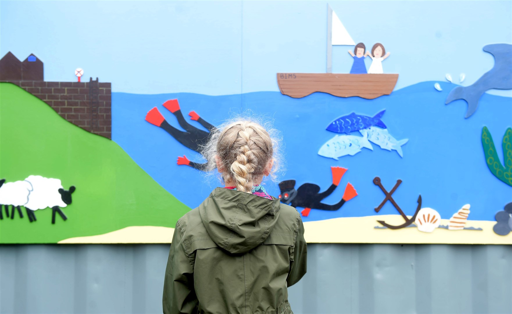 Avoch Primary pupils helped the Black Isle Men’s Shed group paint murals for the side of their storage container at the school. Picture: Callum Mackay